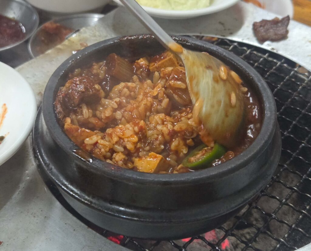 Mixing rice into beef doenjang-jjigae the local way at Sanbul Deungsim — a must-try Korean dining ritual