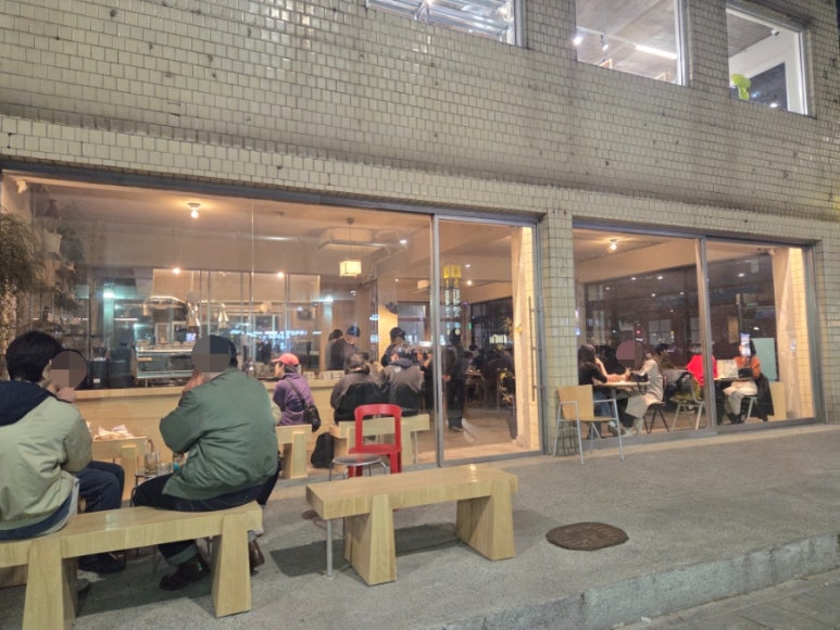 A wide view of Always August Roastery with its large glass windows and outdoor seating.