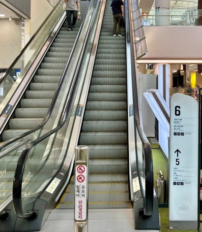 smaller escalator near Olive Young at the cinema entrance 
that’s the one that takes you to the 6th-floor 
