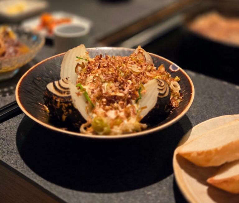 Kuro Tamanegi charred whole onion with miso cream sauce and baguette, signature dish at Negi Sukiyaki Seoul