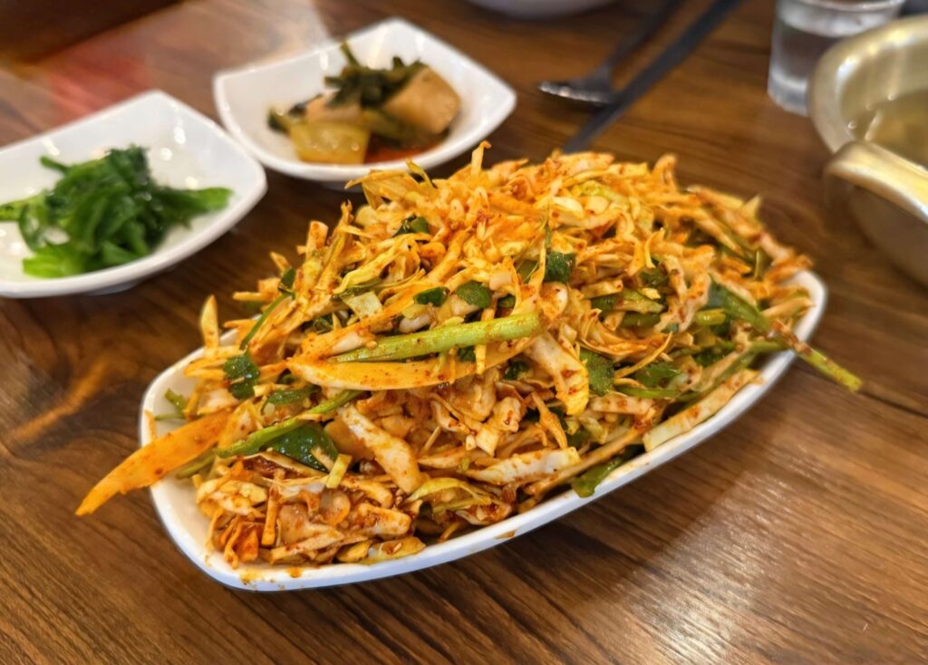 Korean cabbage salad served with grilled cuttlefish