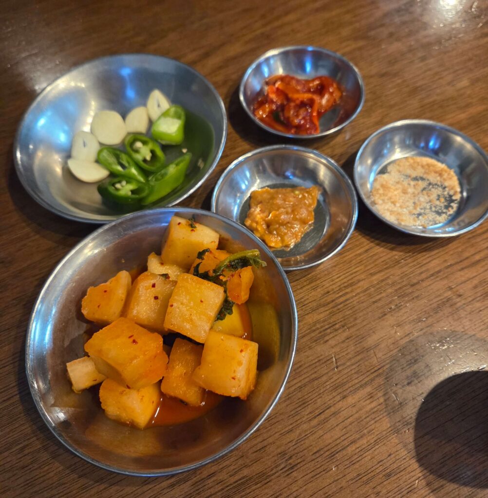 Close-up of crunchy house-made radish kimchi (Kkakdugi), the perfect side for gukbap.