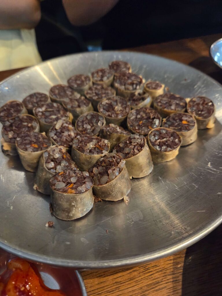 A plate of refined Pi-sundae (blood sausage) served with garlic and dipping sauce