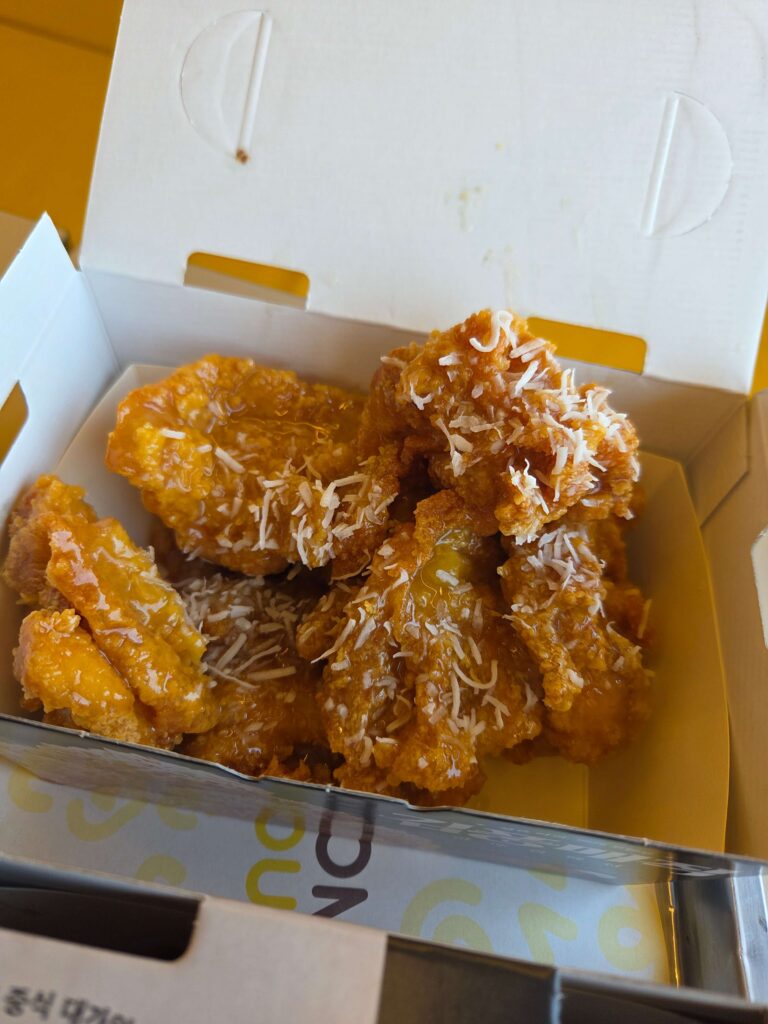 The Magic Big Ssai Chicken from the Kimpoong Collection is topped with pineapple sauce and coconut flakes 