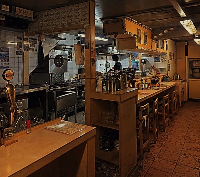 Long tachi counter seating on the first floor of Tetsuro, a Japanese-style bar near Seoul Station.