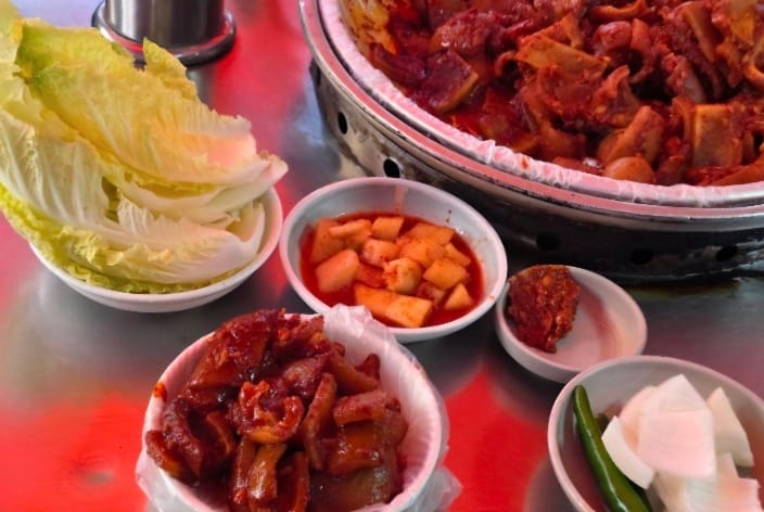 Spicy stir-fried pork skin served with vegetables at Jagalchi market
