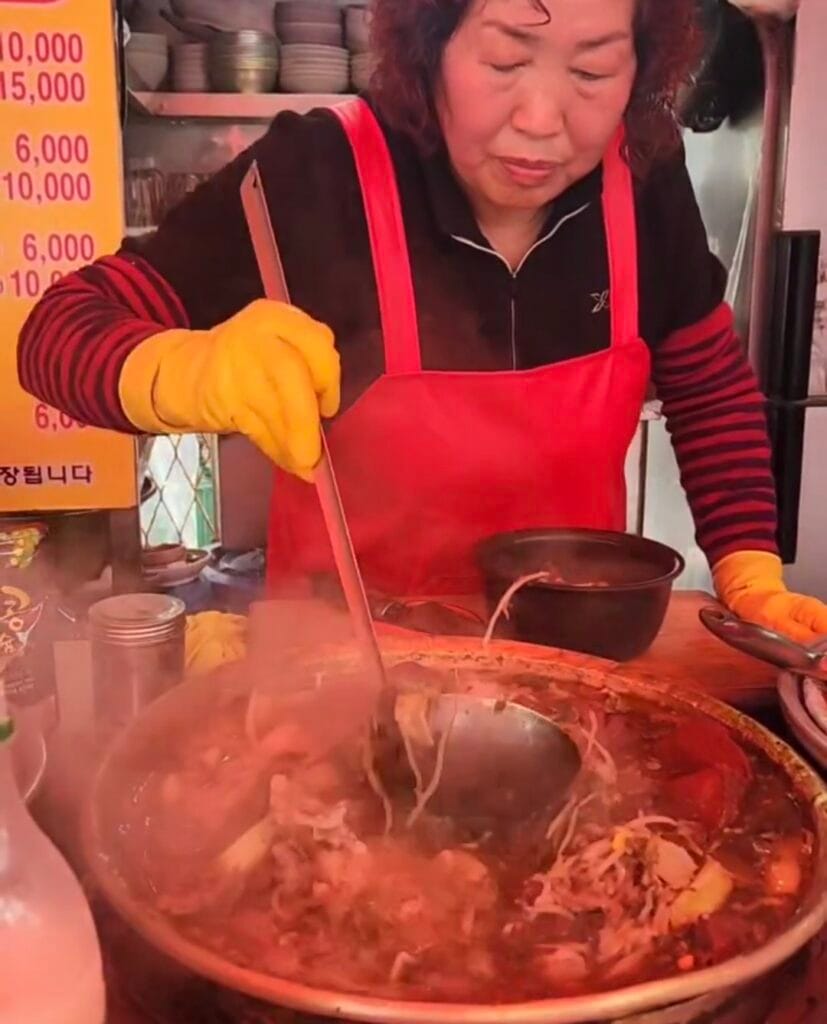A steaming bowl of seonji haejangguk with free broth refills at Gyeongbukjip pojangmacha in Jagalchi Market