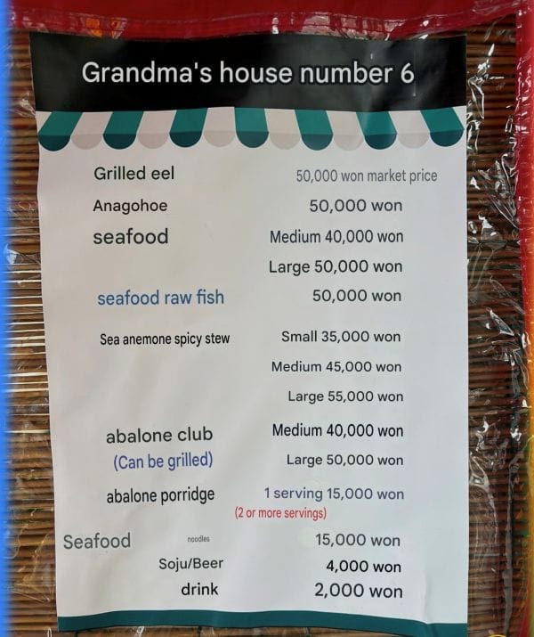 Seafood menu at one of the Hakri Breakwater stalls in Gijang, Busan — no English menu available