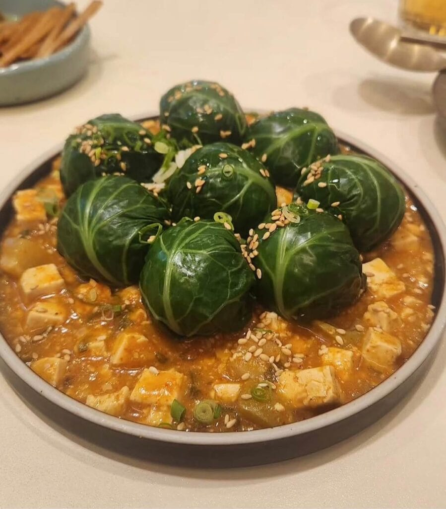 A close-up of Nanpo's famous kale-wrapped rice served with savory soybean paste