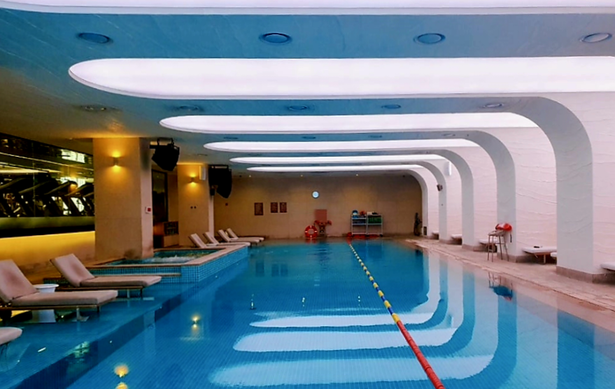 The treadmill zone in the fitness center overlooks the swimming pool