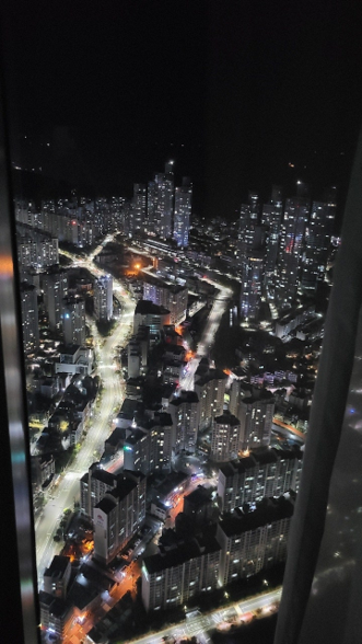 Dazzling city lights and the serene night city viewed from the high floors of Busan LCT.