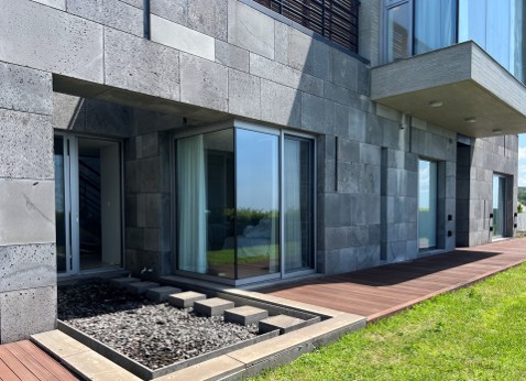 A stunning harmony of sunlight and natural stone, showcasing the architect's signature aesthetic of light