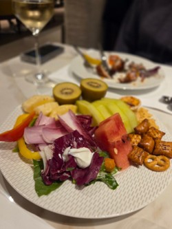 A generous spread ranging from seafood like endive, shrimp, and salmon to meat , fruits dishes