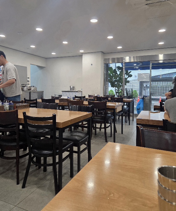 Bustling interior seating and dining atmosphere of Jinmi Pyeongyang Naengmyeon